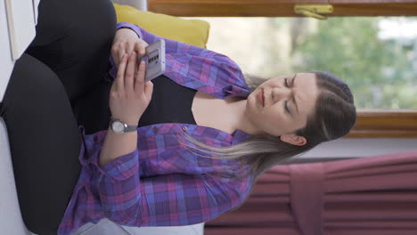 Vertical-video-of-Disappointed-woman-texting.